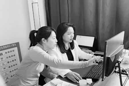           肖迪晨（左）指导工作人员进行数字乡村相关系统的操作和使用。 图片由受访者提供        