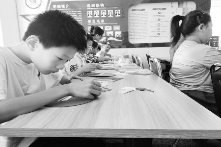 孩子们认真拼贴 本报记者 孟存田 摄